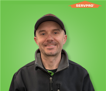 male employee wearing a black SERVPRO jacket and hat