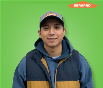 male employee wearing a blue vest and SERVPRO hat